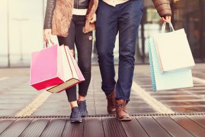 people walking around with shopping bags